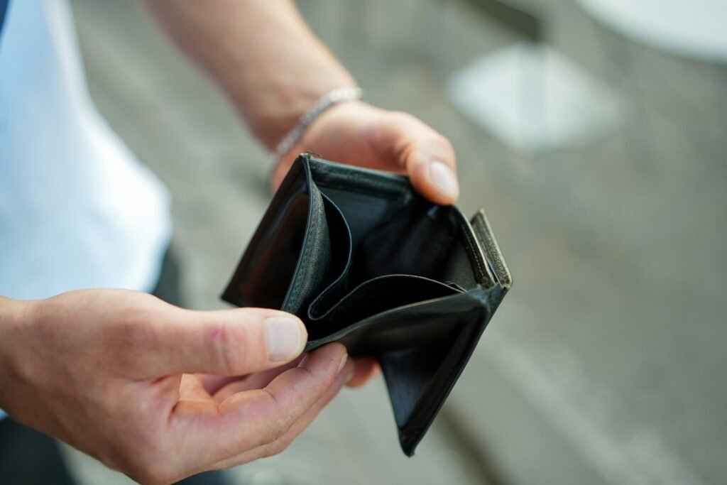 man showing empty wallet