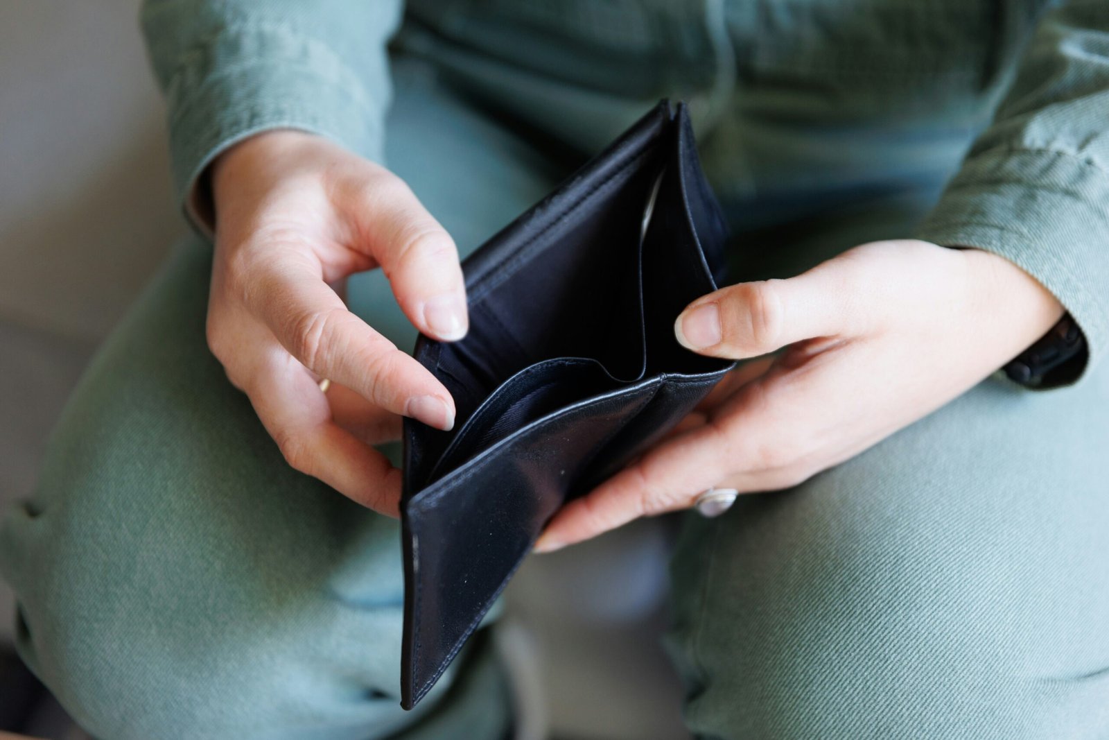 Man with an empty wallet showing how inflation takes 
