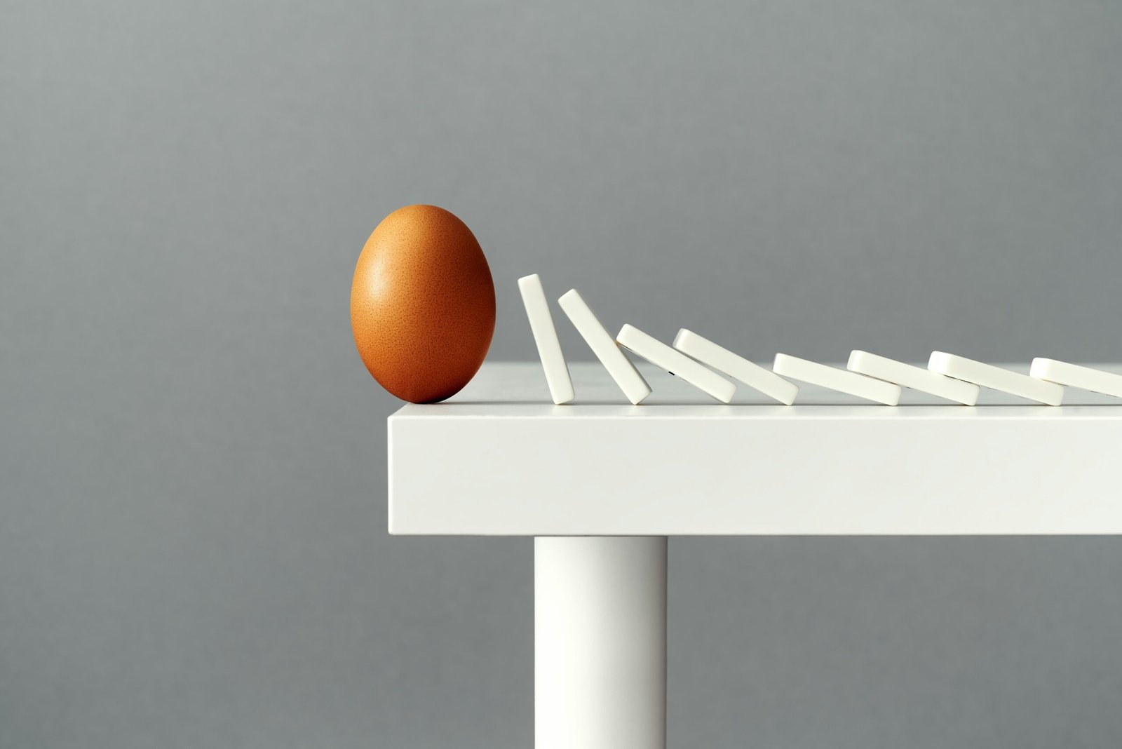 Egg on a ledge about to fall off showing mistakes