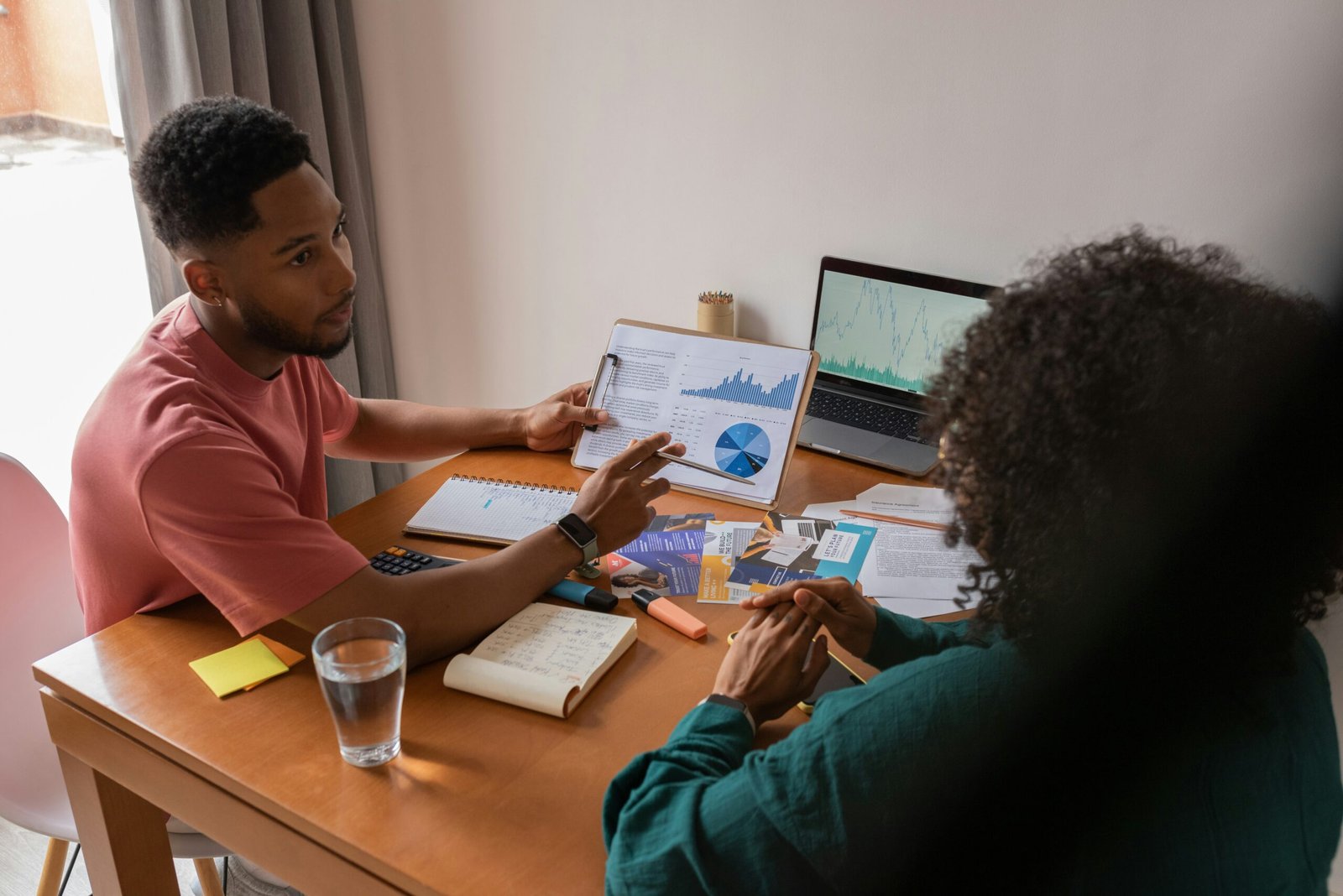 Man showing his mother an investment chart
